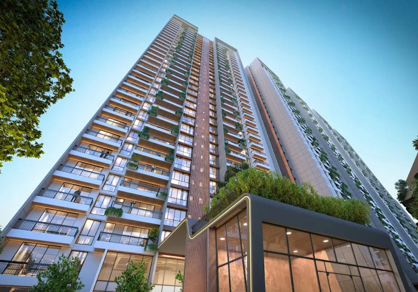 Austin Yana - tower facade rising above the glazed clubhouse entrance, Tathawade Pune